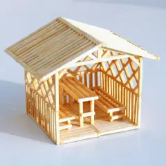 Miniaturowy domek z zapałek z ławkami i stołem. Inspiracja, jak zrobić domek z zapałek.